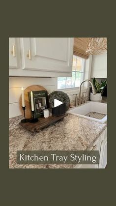 a kitchen counter top with an image of a sink and book on the counter next to it