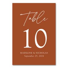 a table number card with the word table 10 printed on it in white and brown