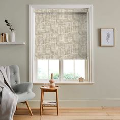 a living room scene with focus on the window blinds and chair in the foreground