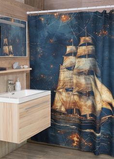 a bathroom with a shower curtain that has a ship on it and stars in the sky