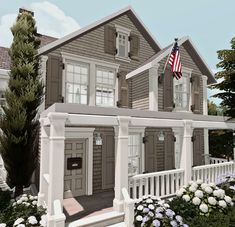 a large gray house with an american flag on the porch