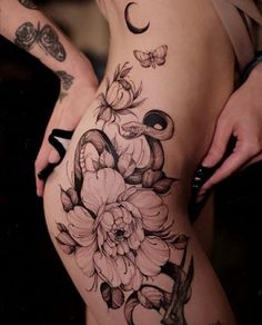 a woman's thigh with flowers and butterflies on her side, while the lower half is