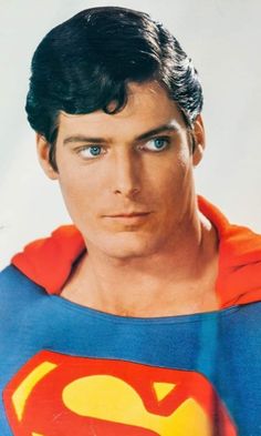 a close up of a person wearing a superman costume