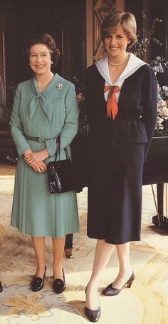 two women standing next to each other in front of a piano