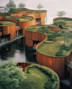 an unusual building with grass growing on the roof and walls is shown in this photo