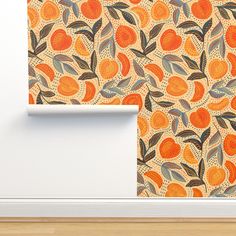 an orange and blue wallpaper with leaves on it next to a white door frame