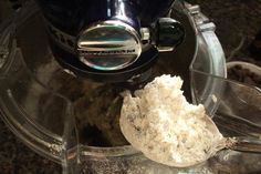 a blender filled with white powder on top of a counter