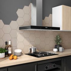 a kitchen with white hexagonal tiles on the backsplash and counter tops