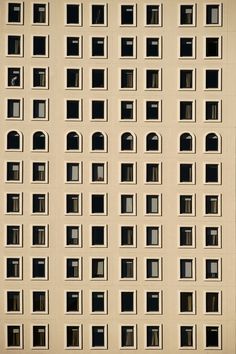 the side of an apartment building with many windows