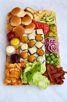 a wooden tray topped with lots of different types of foods and condiments on top of it