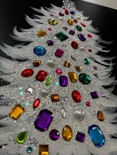 a white christmas tree with many different colored jewels