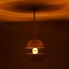 a light that is hanging from the ceiling in a room with no one around it