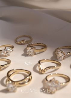 six different types of rings on a white surface with the names ella and eleven other sizes