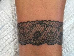 a black lace tattoo on the leg