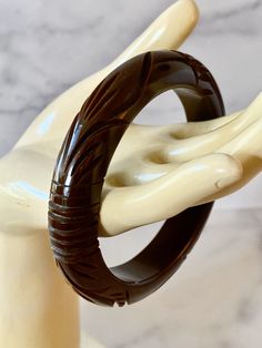 Gorgeous Foliate Carved Chocolate Bakelite Bracelet. Features a carved popular geometric pattern of circles and foliate design. The bracelet is in very good vintage condition, sold as found. Incredible statement set, true vintage. Standard 2.5 inch opening. 1/2 Inch wide width. I love mixing all the different shades of Chocolate, please be sure to see the other chocolate colored Bakelite bangles I have for sale You will not be disappointed with this beauty, it can hold its own or show up in a St Antique Brown Carved Jewelry, Brown Carved Bracelet Jewelry, Collectible Carved Bangle Bracelets, Antique Carved Bangle For Formal Occasions, Brown Carved Round Jewelry, Round Brown Carved Jewelry, Art Deco Carved Round Jewelry, Formal Antique Carved Bangle, Vintage Intaglio Bracelets For Formal Occasions