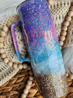 a purple and blue glitter tumbler with the words happy new year written on it