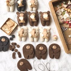 several small teddy bears made out of cookies and other items on a table with scissors