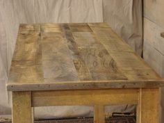 a wooden table sitting on top of a rug