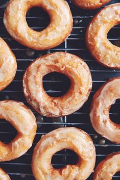 several glazed donuts sitting on top of a cooling rack