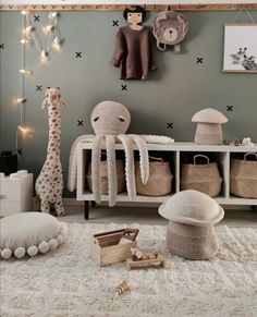 a baby's room with stuffed animals and toys on the floor in front of it