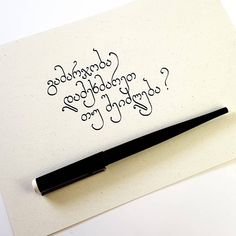 a pen sitting on top of a piece of paper next to a writing sample with the words goodbye, goodbye, good luck, and go ahead