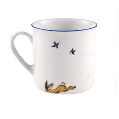 a white coffee cup with blue trim and birds on the side, sitting in front of a white background