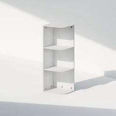 a white shelf sitting on top of a white wall next to a shadow from the floor