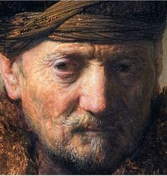 an old man with a hat and fur on his head is looking at the camera