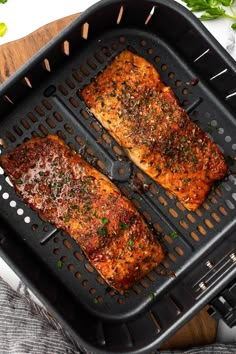 two pieces of cooked meat sitting on top of a grill