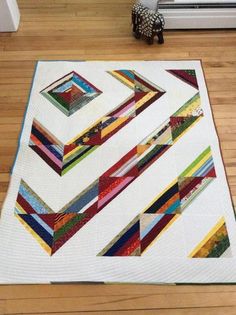 a quilted table topper sitting on the floor