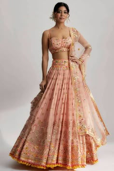 This lehenga set is perfect for a glamorous wedding ceremony, as it exudes elegance and grace. The vibrant colors and shimmering sequins make it a statement piece that will surely turn heads and leave a lasting impression. Be prepared to steal the spotlight and make a memorable entrance in the ruah gathered lehenga set. Its beautiful craftsmanship, intricate details and vibrant colors will make you feel like a queen on your special day. Pink Georgette Lehenga, Gathered Lehenga, Middle Class Family, Gopi Vaid, Class Family, Mehendi Outfit, Lehenga Design, India Trip, Indian Outfits Lehenga