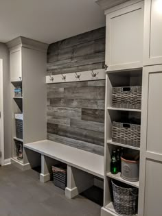 a room that has some shelves and baskets on the wall next to each other in it