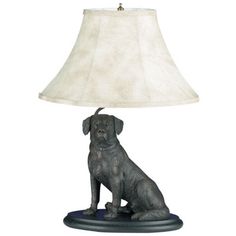 a dog lamp sitting on top of a table next to a white lampshade