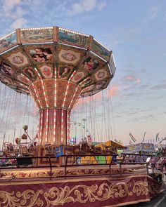 an amusement park carousel with lights and rides