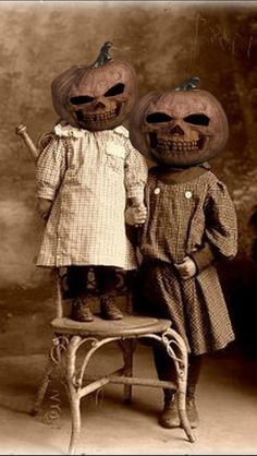 an old black and white photo of two children dressed up as pumpkins