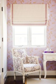 a white chair sitting in front of a window