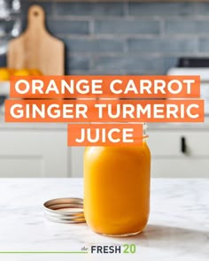 orange carrot ginger turmeric juice in a glass jar on a kitchen countertop