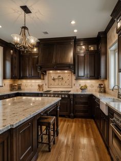 a large kitchen with wooden cabinets and marble counter tops, along with an island in the middle