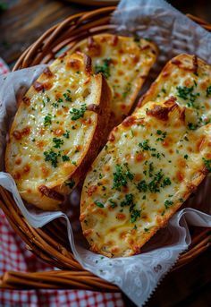 two pieces of bread with cheese and herbs in a wicker basket on a checkered table cloth