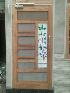 a wooden door with decorative glass on it