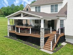 a house with a deck and patio in the front yard