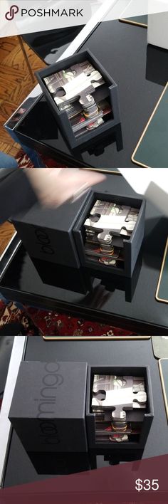 two black boxes sitting on top of a table next to each other with their lids open