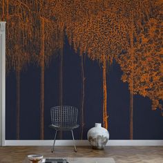 a living room with an orange tree mural on the wall and a chair in front of it