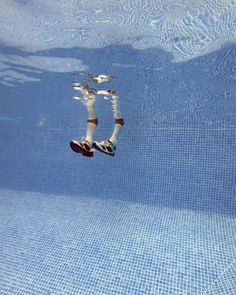 a person floating in the water with their feet up