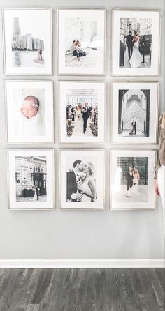 a woman standing in front of a wall with pictures hanging on it's side