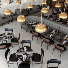 an overhead view of a restaurant with tables, chairs and lamps on the wall above them