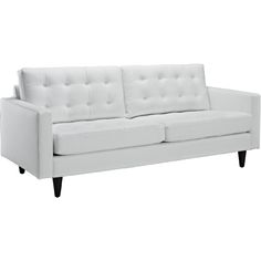 a white couch sitting on top of a wooden floor