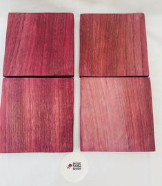 three pieces of red wood sitting next to each other