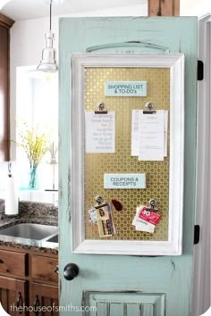 an old door is decorated with magnets and papers on the front, as well as a bulletin board