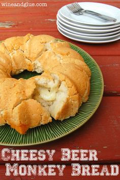 a piece of bread that has been cut into pieces and is on a plate with the words cheesy beer monkey bread